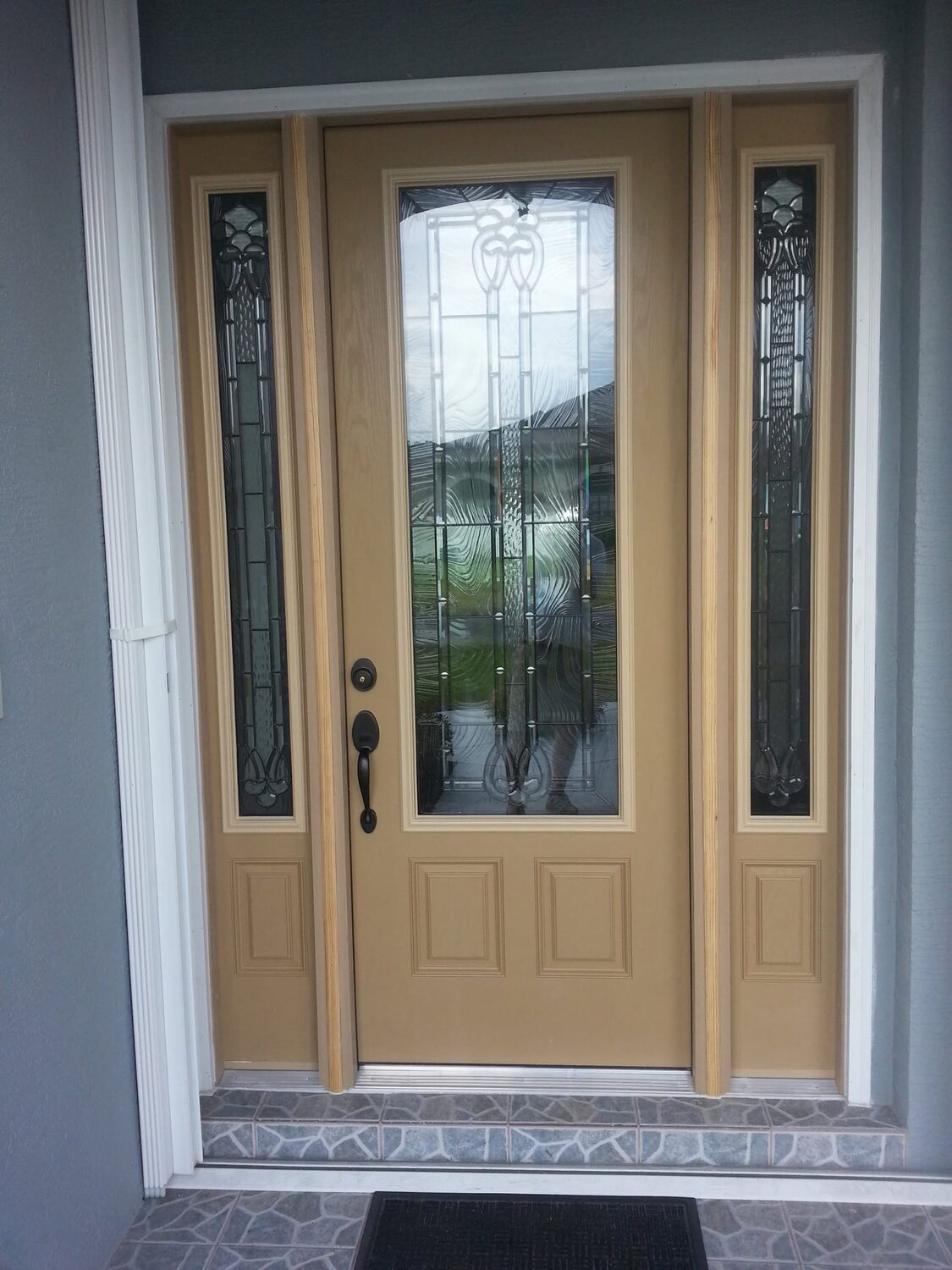 Custom wood-look double entry door with decorative glass