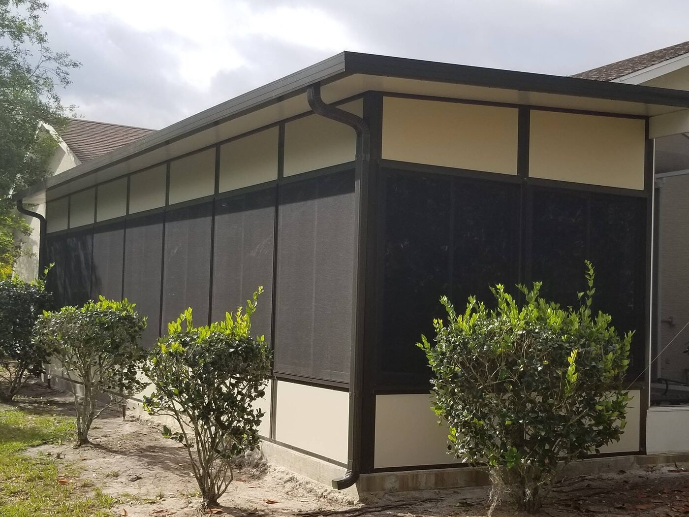 Bronze aluminum screen enclosure on a Florida home