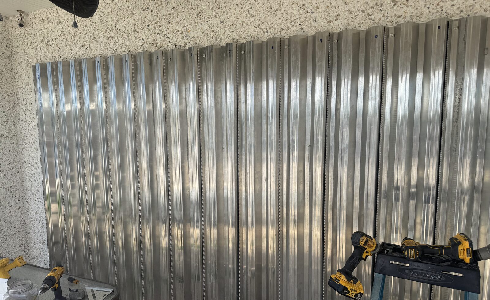 Aluminum storm panels installed across a lanai opening